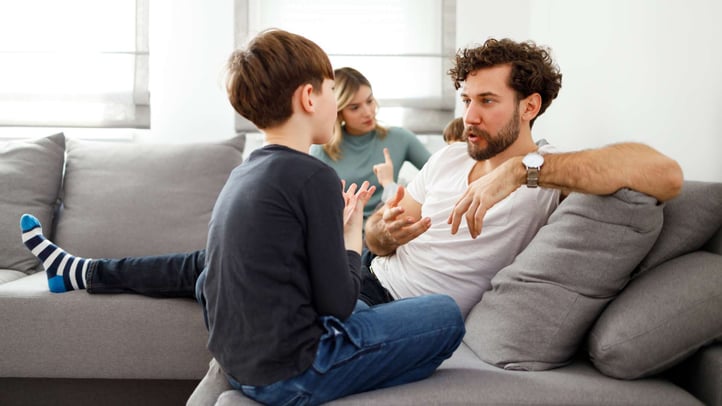 father talking to his young son