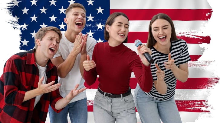 four teenagers singing karaoke with american flag in the background