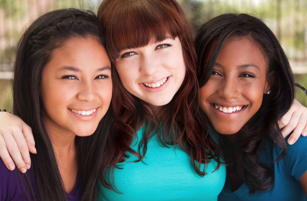 three teen girls smiling