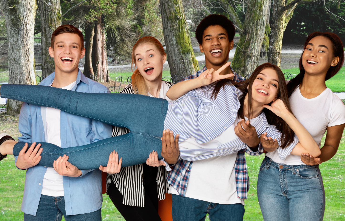 four teens holding a smiling teen girl