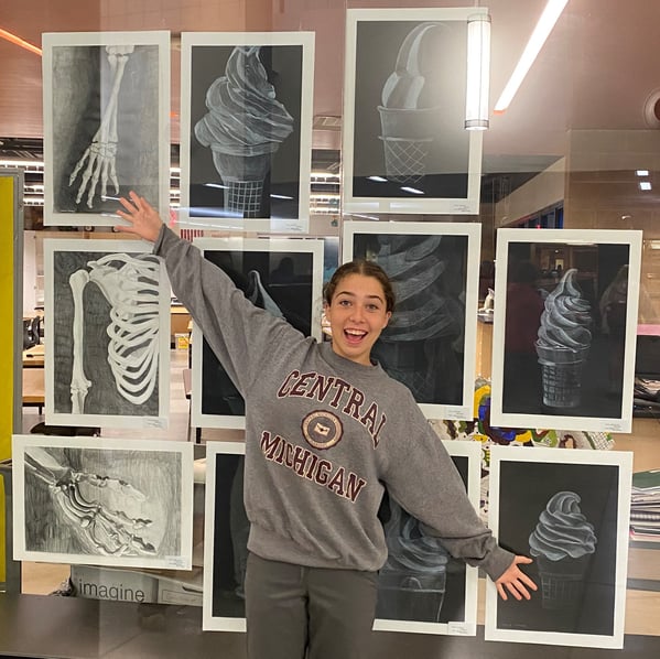 girl standing in front of art display