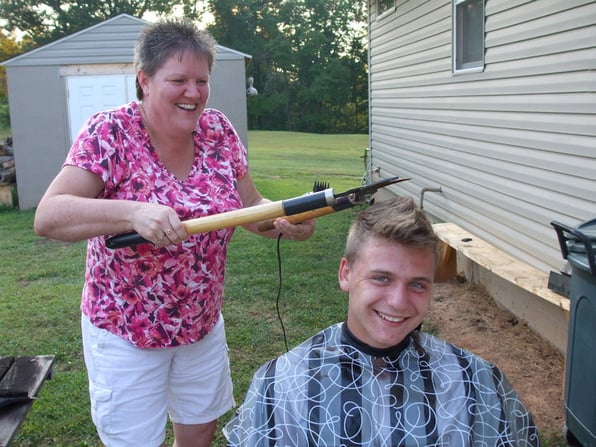 funny photo of mother trimming hair with pruning shears