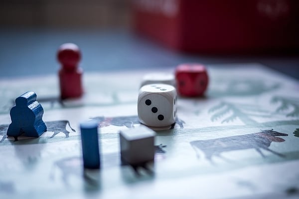 various game token and a die on a game board