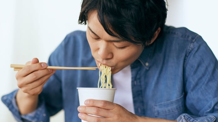 guy slurping noodles with chopsticks