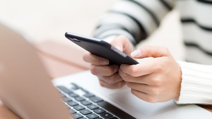 hands texting on a phone