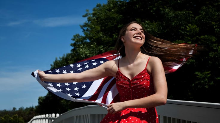 happy teenage girl running with american flag