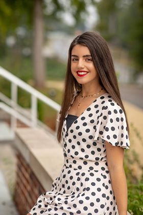 beautiful Spanish exchange student posing in a black and white polka dot dress