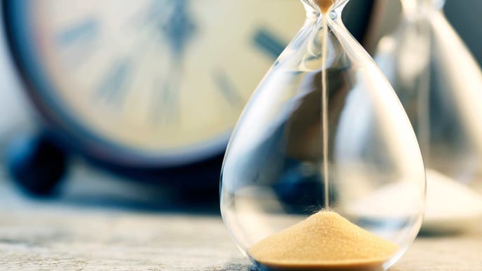 hourglass with clock in background