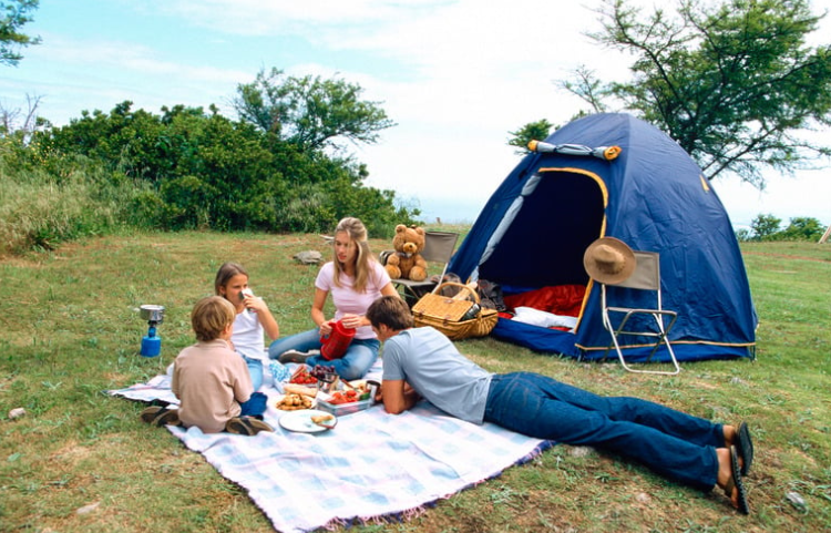 teen boy and younger kids camping