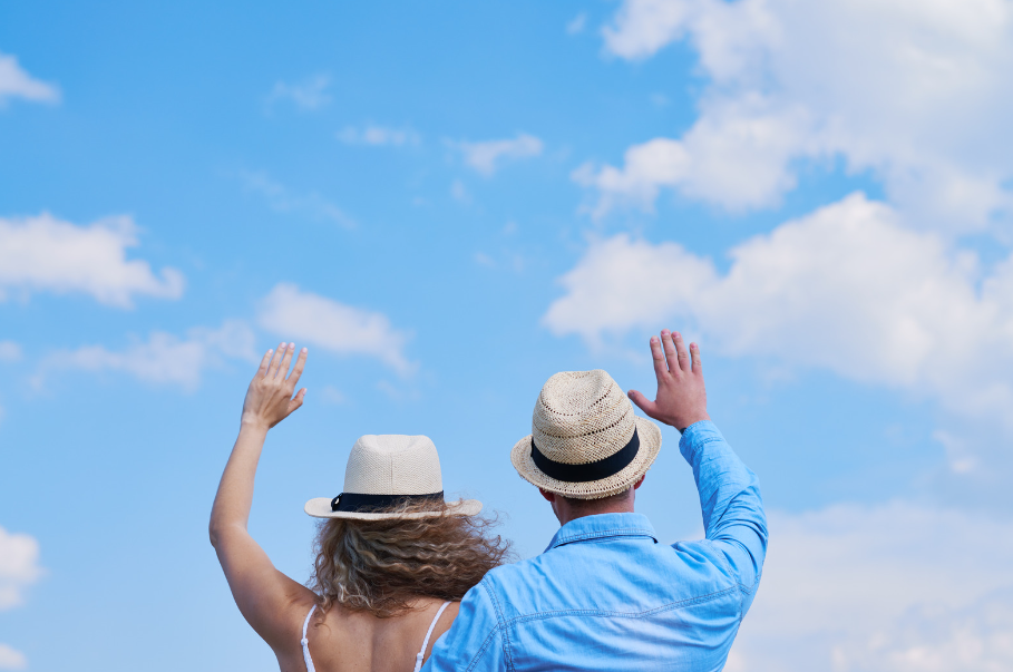 couple waving to sky