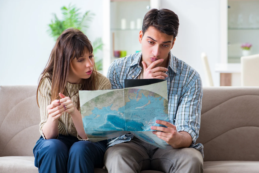 couple looking at map and thinking