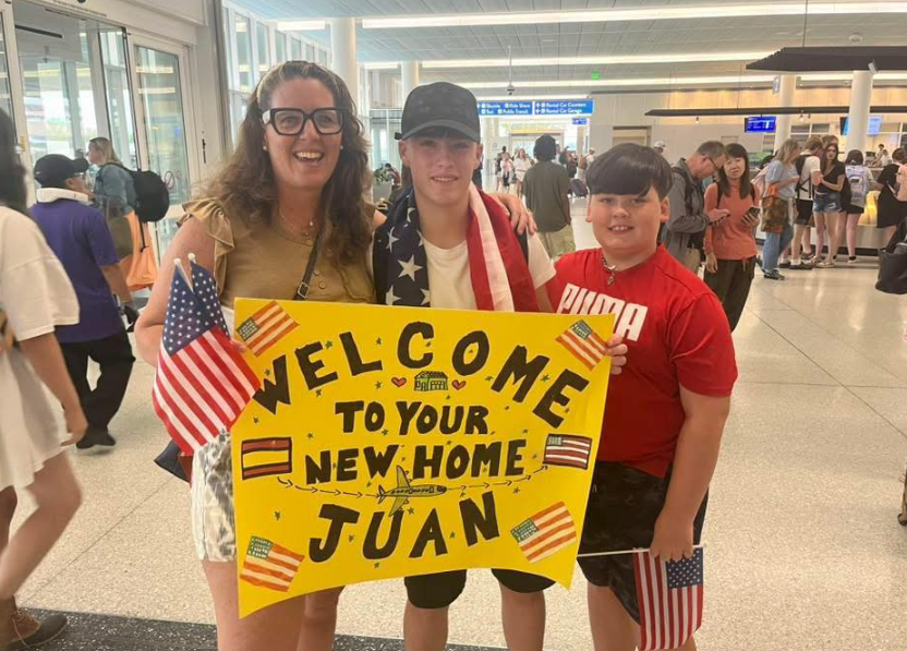 Mom and son welcoming exchange student at airport