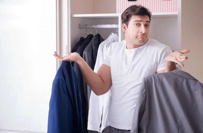 young man holding suit jackets