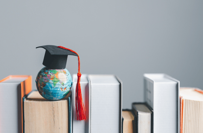 tiny globe atop books