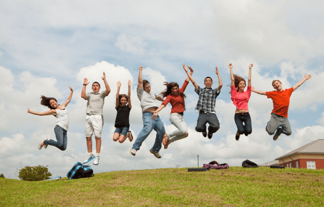 group of teens jumping