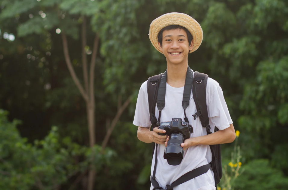 smiling Thai boy with camera
