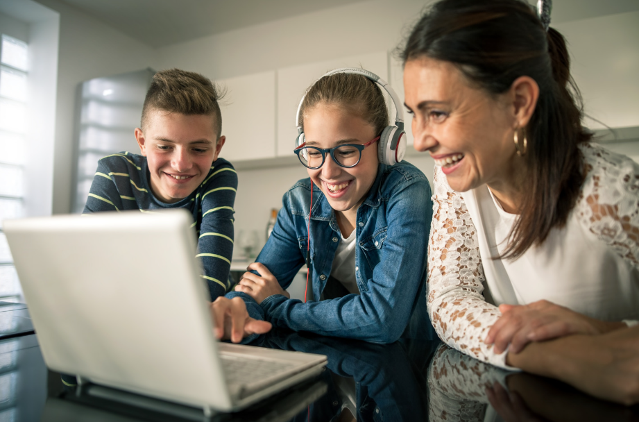 mom and kids smiling at computer