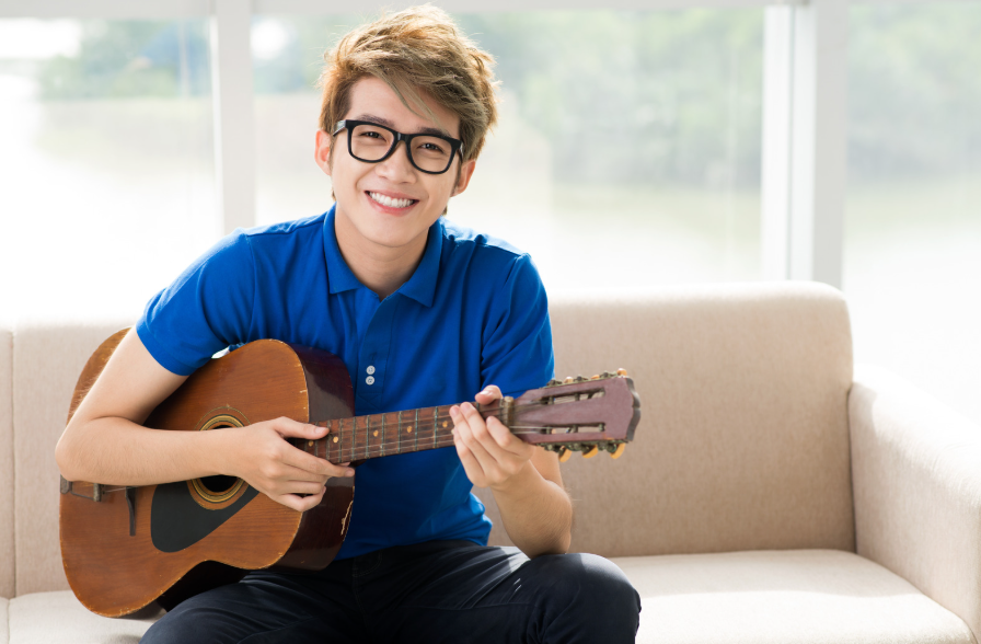 Asian boy playing guitar