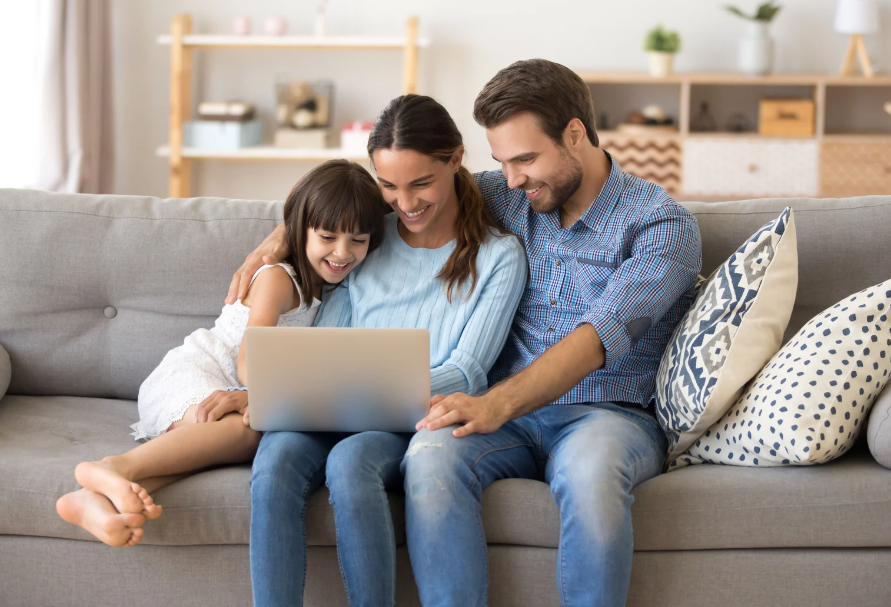 family on couch looking at computer