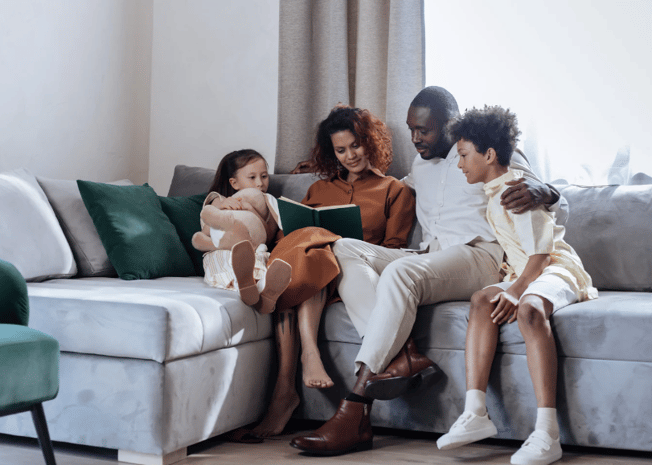 Family reading together on the couch