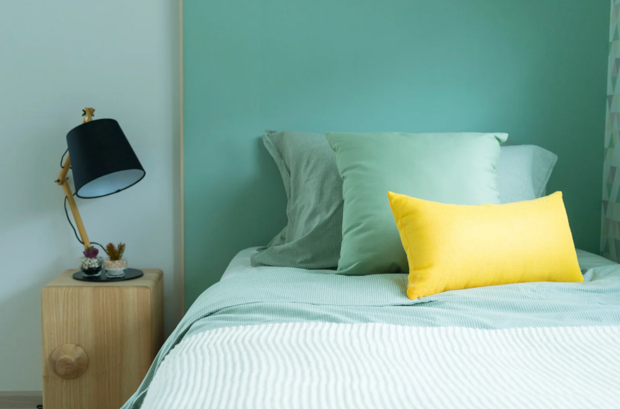 modest bedroom with bed and side table