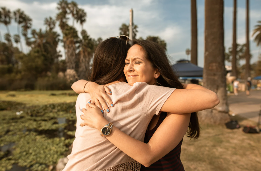 mom hugging daughter