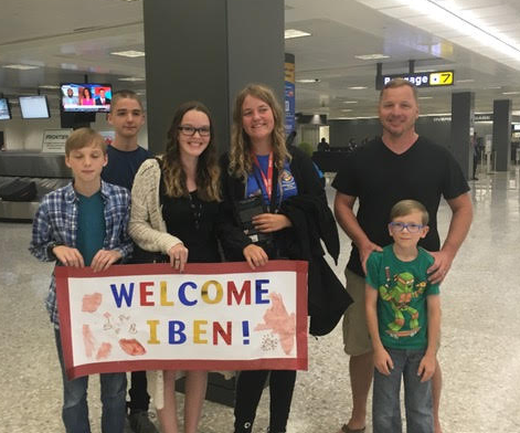 family with student at airport