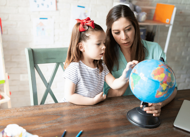 young girl and mom with globe