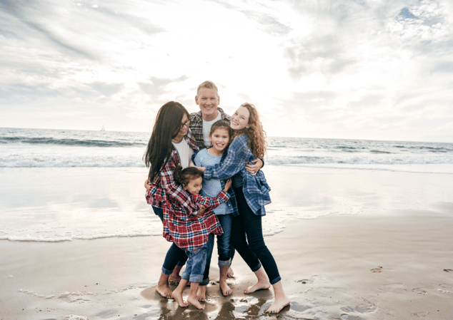 famliy hugging on the beach