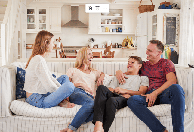 family laughing on the couch