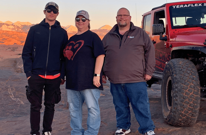 host parenst and exchange student with jeep and beautiful landscape