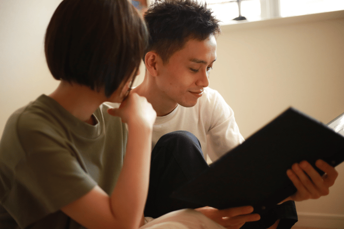 two teens looking at yearbook