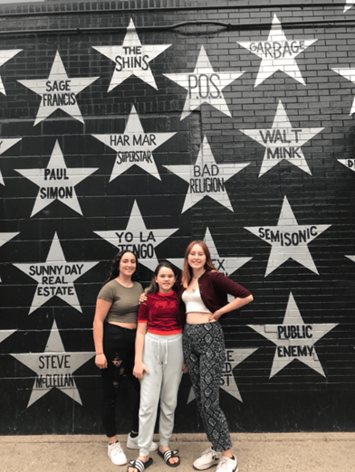 3 girls in front of star wall
