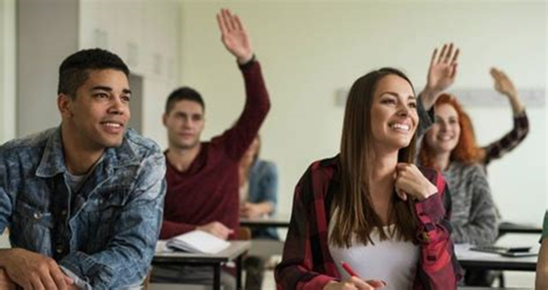 teens in class raising hand