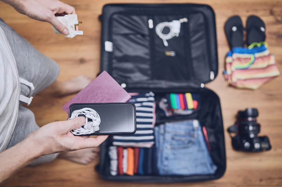 young man packing suitcase