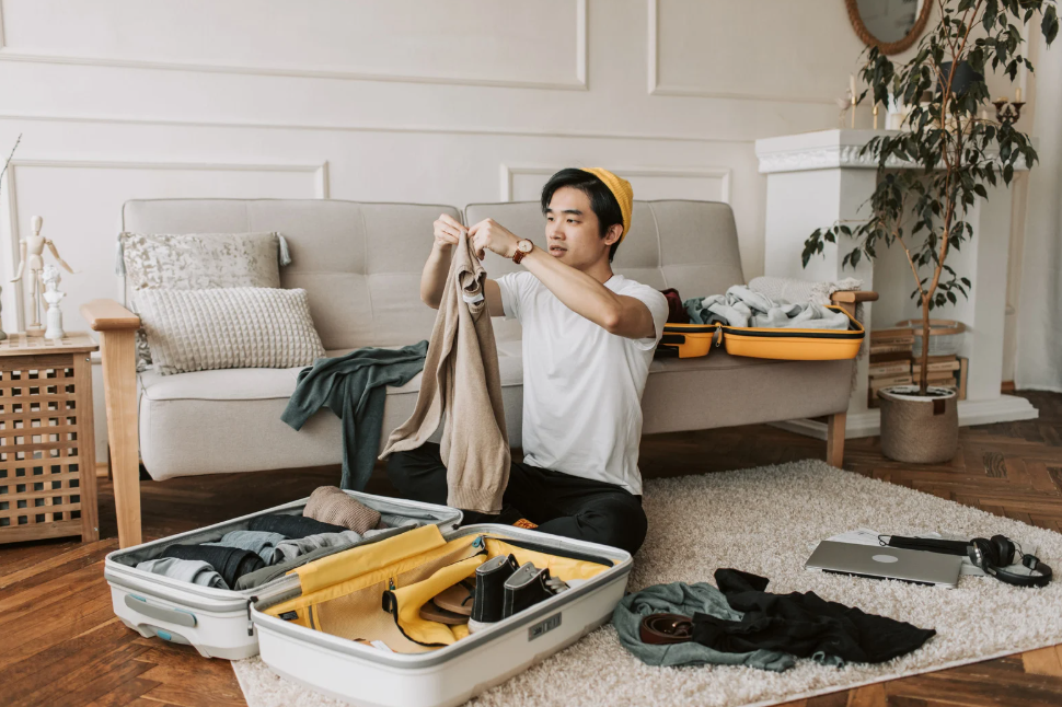 Asian teen boy packing