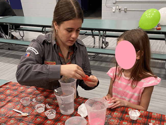 teen girl helping child