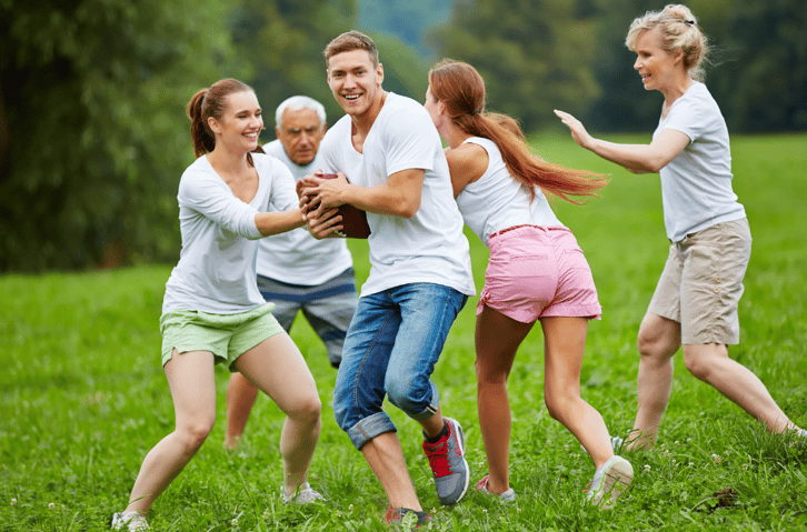 family playing football in the yard