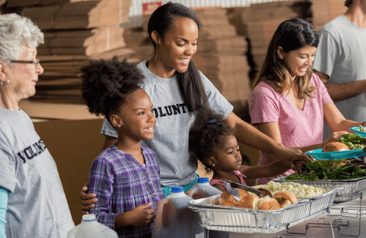 family serving food at shelter