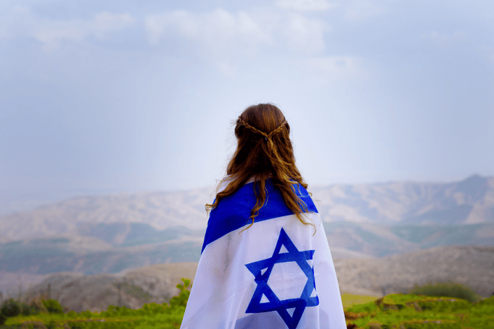 girl with Israeli flag across shoulders