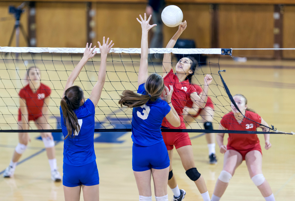 teen girls playing volleyball