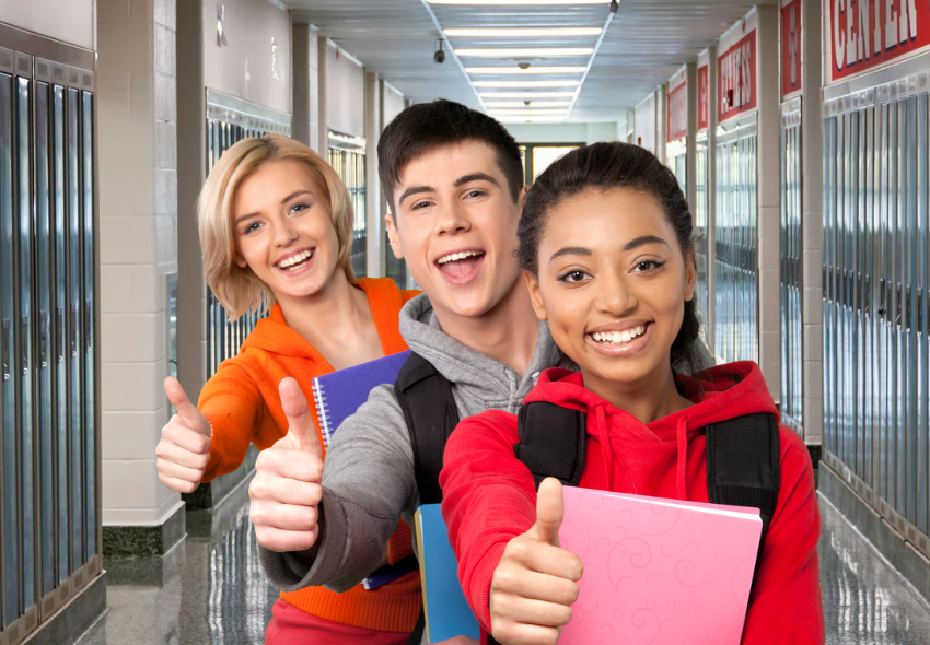 three teens in hall at school