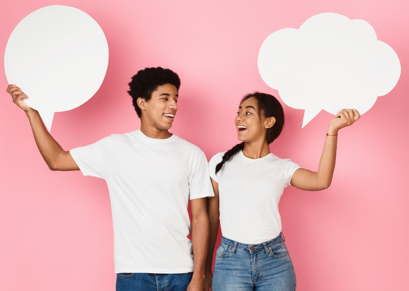 two teens holding conversation bubbles