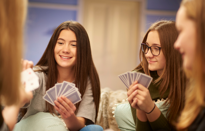 teen girls playing cards