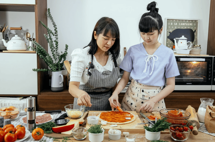 mother and daughter cooking