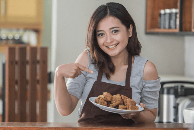 girl holding plate of food