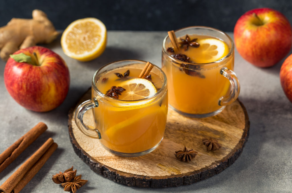 spiced cider in mugs with orange and cloves