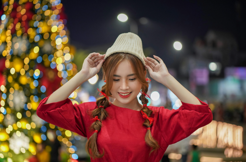 Japanese girl with Christmas lights behind