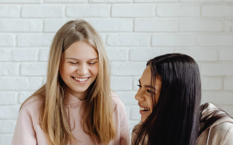 two teen girls smiling