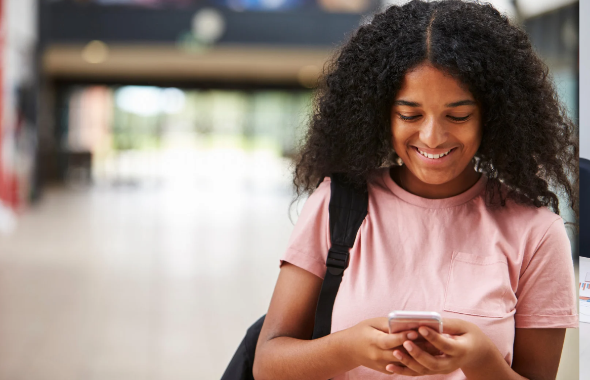 teen girl smiling and texting
